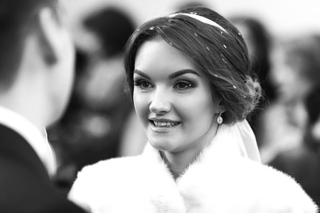 Bride smiles while looking at the fianceの写真素材