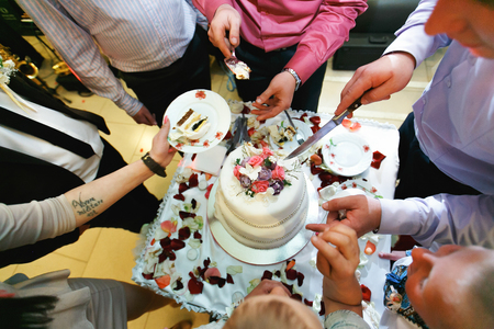 Guests share a wedding cakeの写真素材