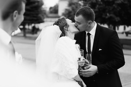Newlyweds passion kiss with champagneの写真素材