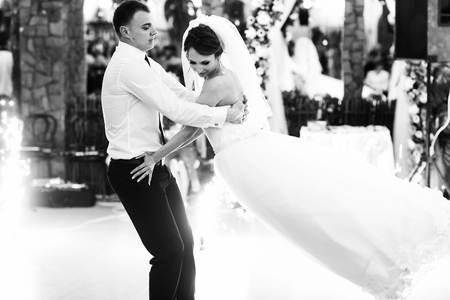 Groom whirls a bride while dancing the very first timeの写真素材