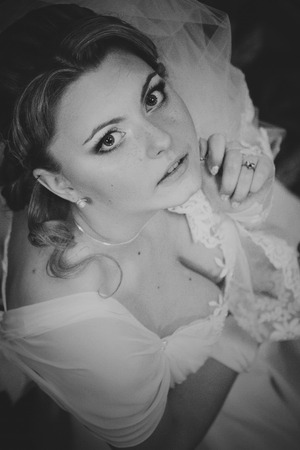 Bride looks worried holding her veilの写真素材