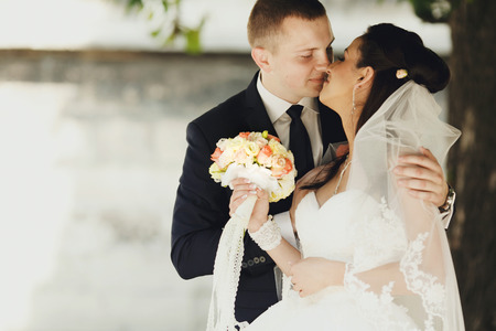 Gentle hugs of just married coupleの写真素材