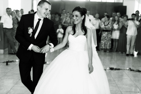 Couple go to the dancefloor to start their wedding danceの写真素材