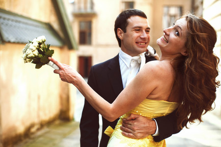 Wedding couple hugs and smilesの写真素材