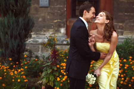 Wedding couple laugh while the walk around the cityの写真素材