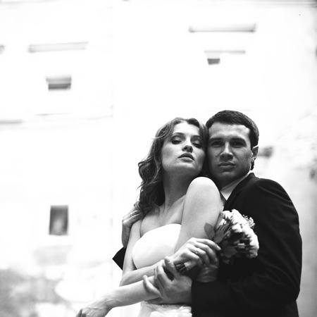 A view from below on the tender hugs of wedding coupleの写真素材