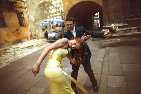 Happy couple has fun while walking around the old townの写真素材