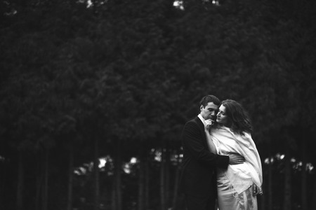Lady in shawl touches tenderly man's faceの写真素材