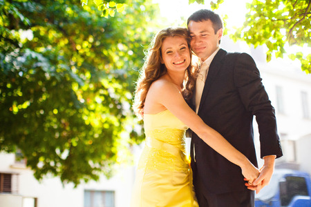 Wedding couple smiles under the green treesの写真素材