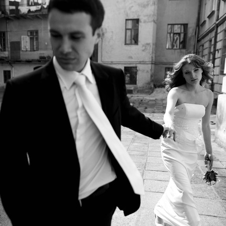 Man and woman look tired while walking around the cityの写真素材