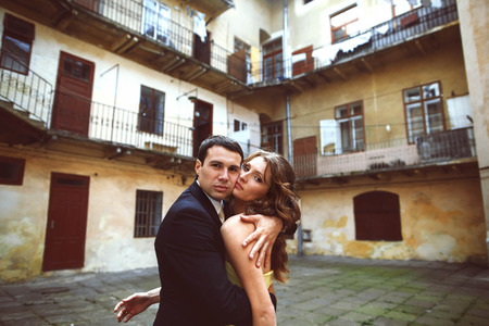 Man looks seriously while lady in yellow dress leans to himの写真素材