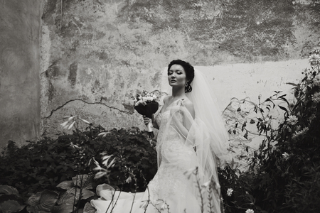 Gorgegous bride poses in the gardenの写真素材