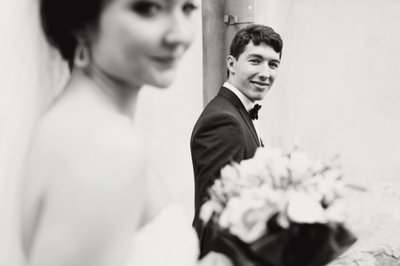 Groom looks tenderly at the sad brideの写真素材