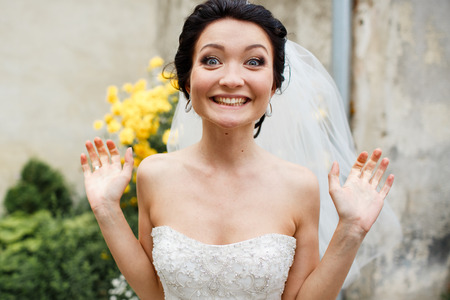 Bride looks funny standing in the gardenの写真素材