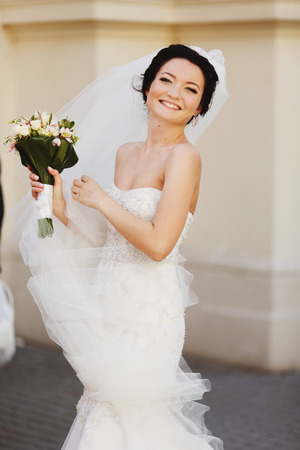 Gorgeous woman in wedding dress smiles sparklingの写真素材