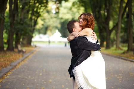 Hold me tight - groom folds a bride in his armsの写真素材