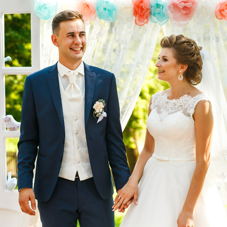Couple in love standing near wedding archwayの写真素材