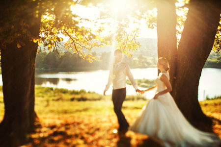 Couple in love walking near lakeの写真素材