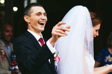 Broad smile of a groom after a wedding ceremonyの写真素材