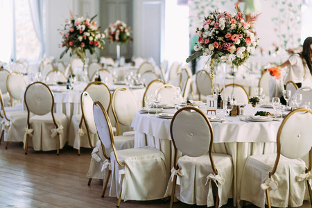 Fancy tables with the bouquets of flowersの写真素材