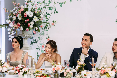 Bride with the groom are watching on the guestsの写真素材