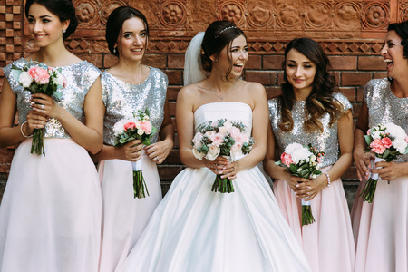 Bride with the bridesmaids in the shining dressesの写真素材