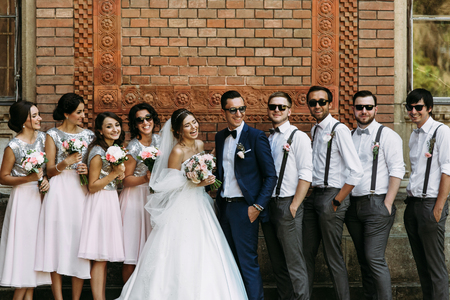 Charming smiles of the couple with the friends on the weddingの写真素材