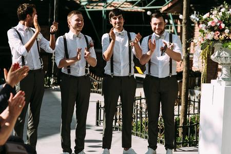 Groomsmen are applauding on the wedding ceremonyの写真素材