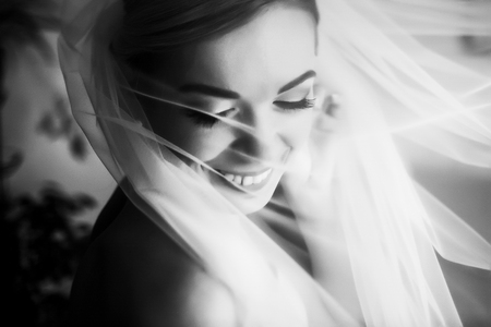 Bride shines under a veil in morning lightsの写真素材