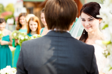 Bride looks charmed listening to the groom's oathの写真素材