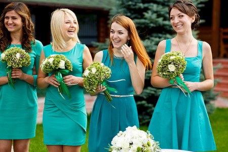Bridesmaids smile while wind bolws their hairの写真素材
