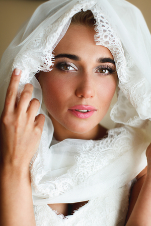 A tender face of a lady enveloped in white shawlの写真素材