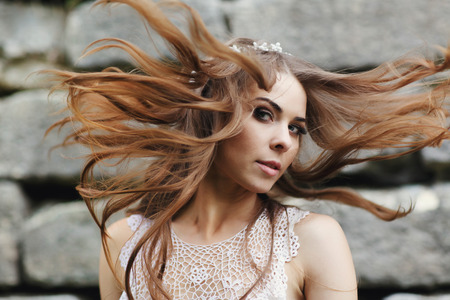 A fabulous woman mixes her hair looking mysteriousの写真素材