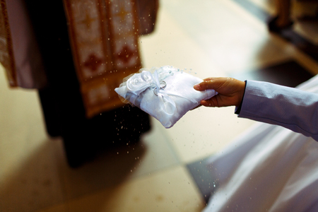 Priest blesses with holy water wedding ringsの写真素材