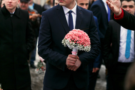 The groom keeps bouquet for brideの写真素材