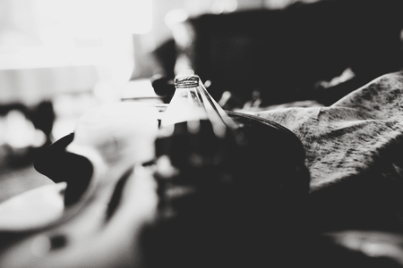 A black and white picture of wedding rings lying on the violinの写真素材