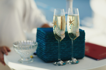 Champagne flutes decorated with pearls and sea starsの写真素材