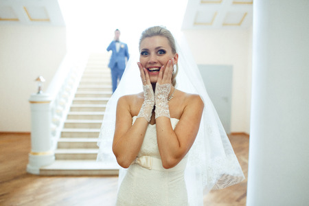Surprised bride and her groom behindの写真素材