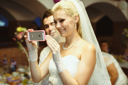 Joyful bride took a photo on the wedding celebrationの写真素材