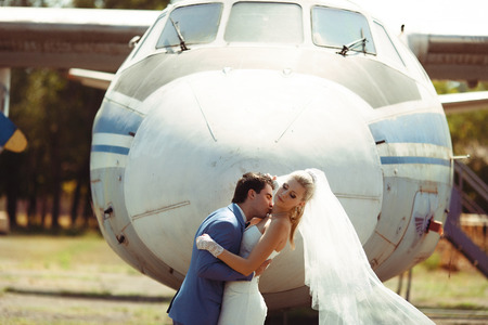 Groom kisses his bride to the neckの写真素材