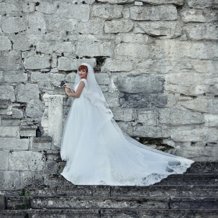 The bride stands near wallの写真素材