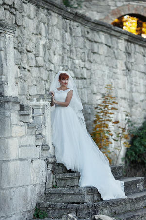 The bride stands near wallの写真素材