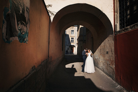 The couple in love embracing near archwayの写真素材