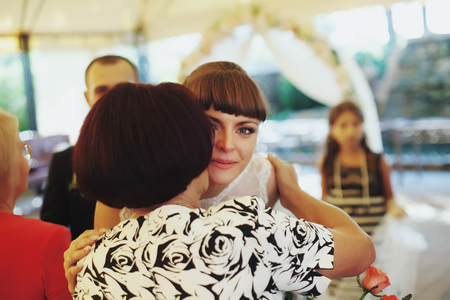 Mother kisses crying brideの写真素材