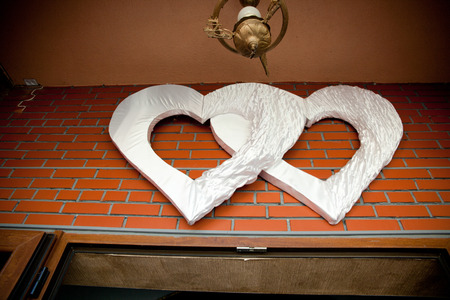 Huge cloth hearts hang under the ceiling outsideの写真素材