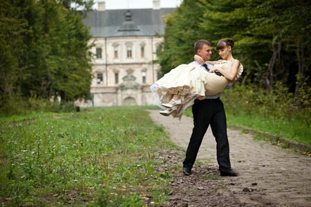 Man carries a dreamy woman along the pathの写真素材