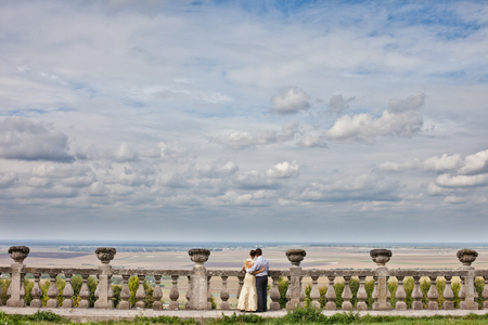 Couple admies blue clouded sky standing on the ruinsの写真素材