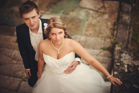 A look from above on the wedding couple standing on the old stone footstepsの写真素材