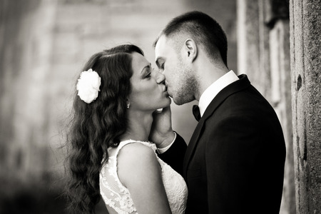 Bride opens her eyes during a kiss with a groomの写真素材