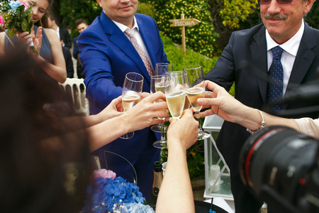 Guests clang the glasses standing outside